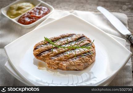 Beef steaks on the white square plate