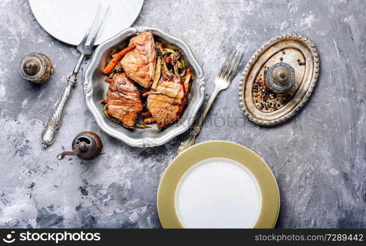 Beef steaks stewed in carrots and green beans. Beef steaks with vegetables