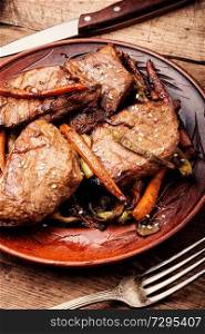 Beef steaks stewed in carrots and green beans. Beef steaks with vegetables