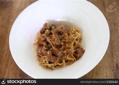 Beef stew spaghetti on wood background