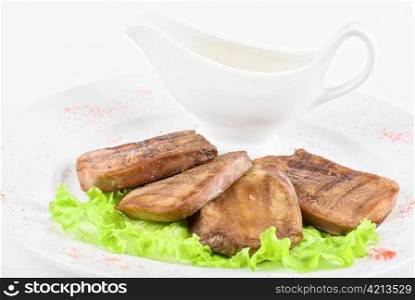 Beef tongue closeup with sauce isolated on a white background