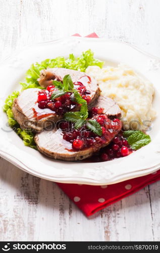 Beef with cranberry sauce and mashed potato