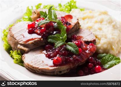 Beef with cranberry sauce and mashed potato. Beef with cranberry sauce