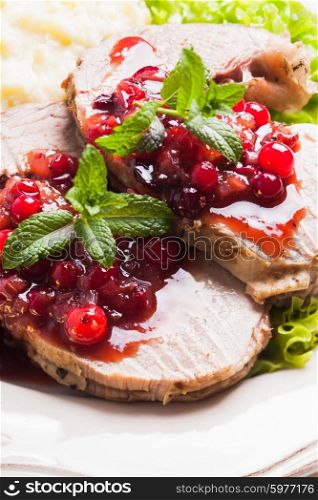 Beef with cranberry sauce and mint close up. Beef with cranberry sauce
