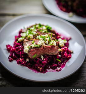 Beefsteak wih beets on wooden background