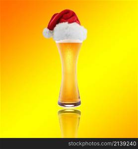 Beer and hat of Santa Claus on a yellow background. Santa Claus hat with beer on a yellow background