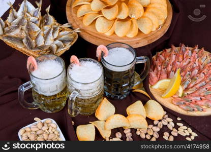 Beer and snacks set: chips, pistachio, shrimp and fish