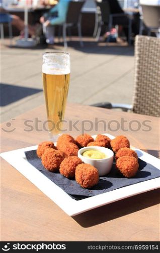 Beer and warm fried snacks, dutch bitterballen: stuffed fried meatballs. Beer and snacks
