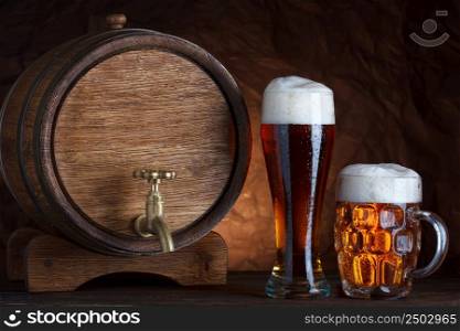 Beer barrel with two beer glasses on wooden table dark still-life