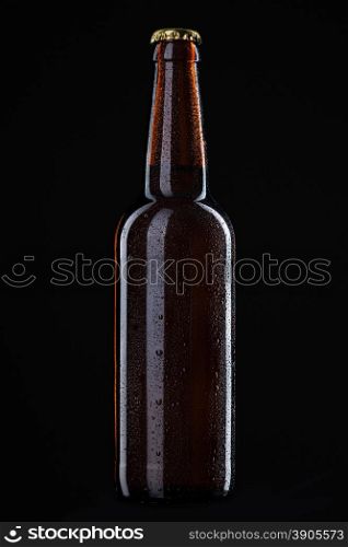 Beer bottle with water drops isolated on black