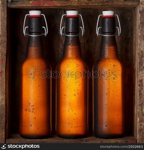 Beer bottles with vintage swing tops in old wooden crate still life