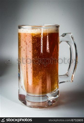 Beer glass full of cold dark beer. Isolated