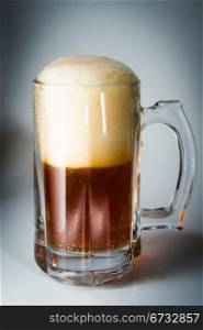 Beer glass full of cold dark beer. Isolated