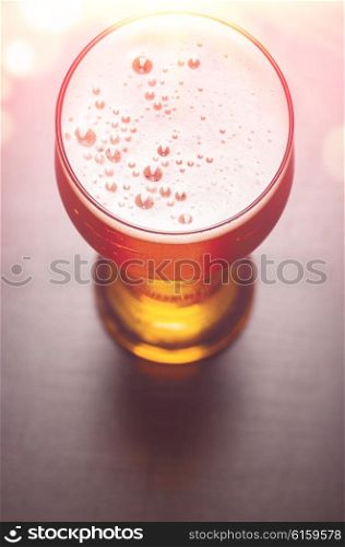 beer glass on black table, view from above
