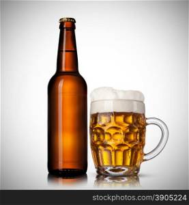 Beer in glass and bottle on white