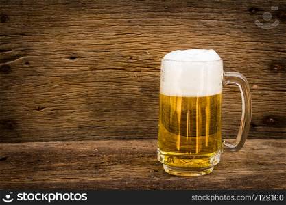 Beer in glass on wood table
