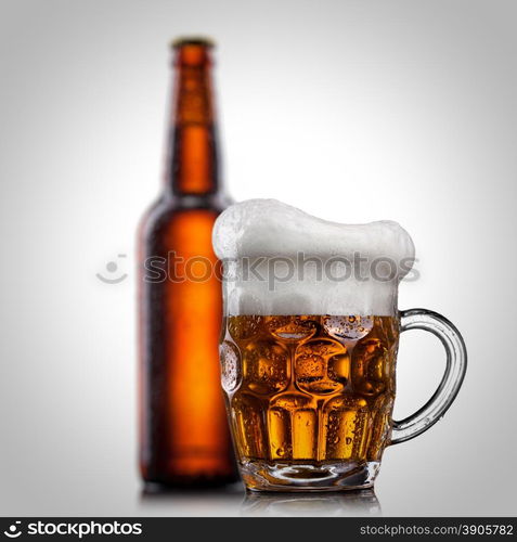 Beer in glass with water drops isolated on white