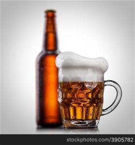 Beer in glass with water drops isolated on white