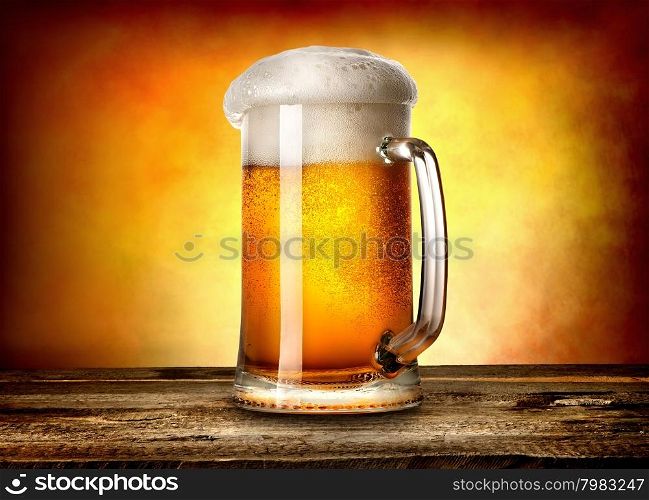 Beer in mug on wooden table and yellow background