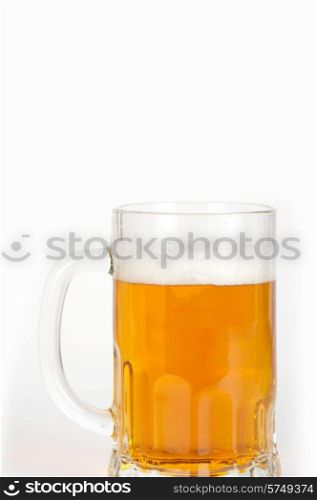 beer into glass on white background. beer glass