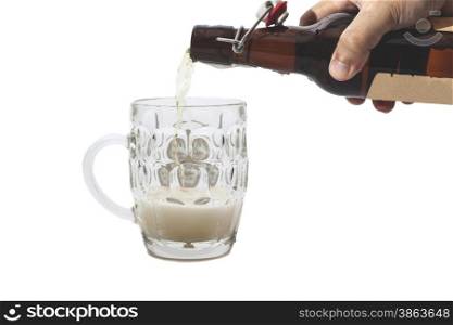 Beer is Pouring into mug on white