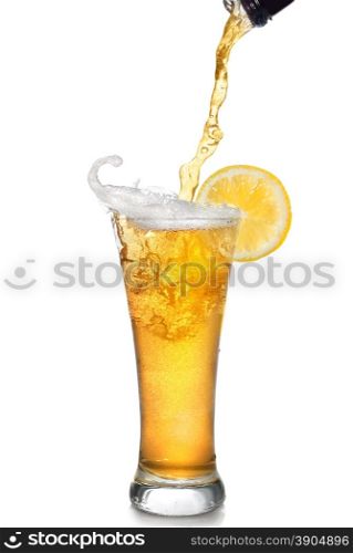 Beer pouring from bottle into glass with lemon isolated on white
