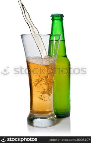 Beer pouring from into glass isolated with bottle on white
