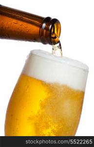 Beer pouring into glass on white background