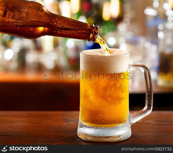 beer pouring into mug in a bar