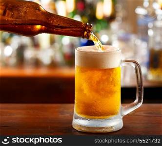 beer pouring into mug in a bar