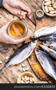 beer with fish. dried delicious fish, with a glass of beer