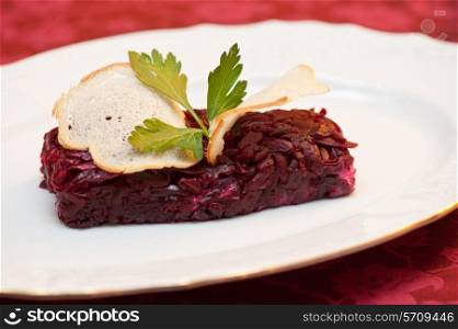 beet salad with rusk bread at plate