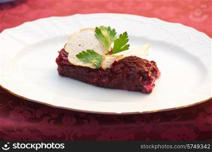 beet salad with rusk bread at plate. beet salad