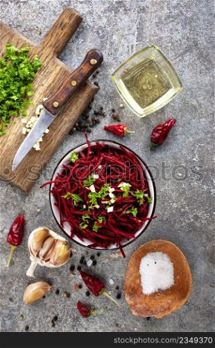 Beetroot salad with oil and nuts in white bowl. Selective focus.