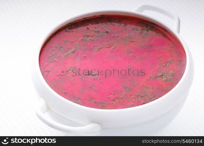 Beetroot soup in the white bowl close up