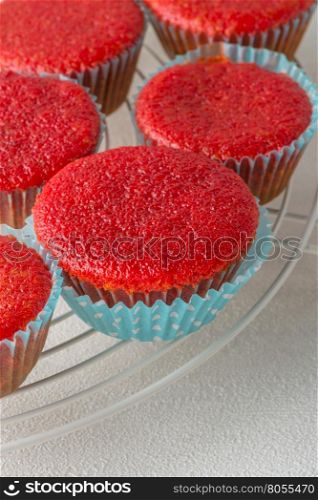 Beetroot velvet cupcakes on white table.