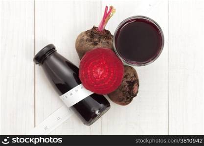 Beetroot with beet juice and mesuring tape