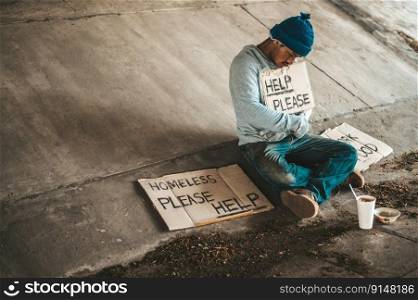 Beggars sitting under the bridge with a sign, help please.