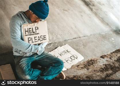 Beggars sitting under the bridge with a sign, help please.