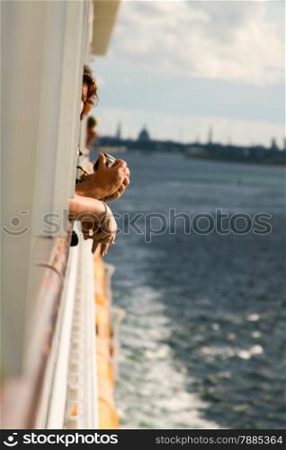 Beginning of a cruise. Hands of passengers.