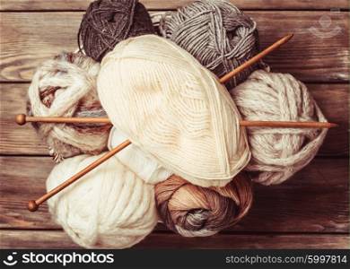 Beige and gray color threads and wooden knitting needles. Beige and gray