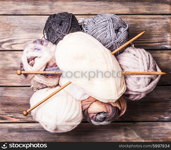 Beige and gray color threads and wooden knitting needles. Beige and gray