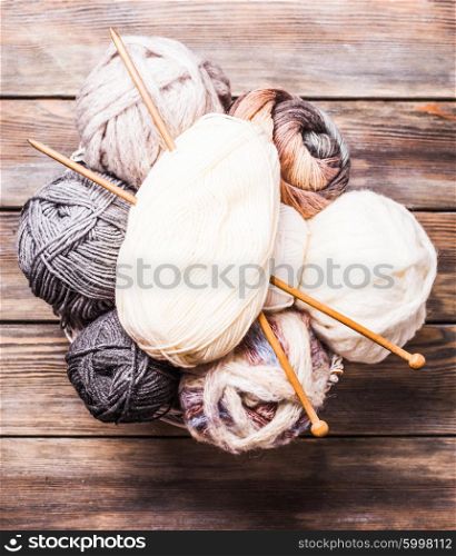 Beige and gray color threads and wooden knitting needles. Beige and gray