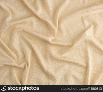 beige satin textile fabric with embroidery elements, piece of canvas for sewing curtains and things, full frame. Crumpled textile satin, great design for any purposes.