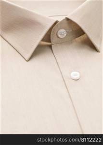 beige shirt with focus on collar and button, close-up. cotton shirt, close-up
