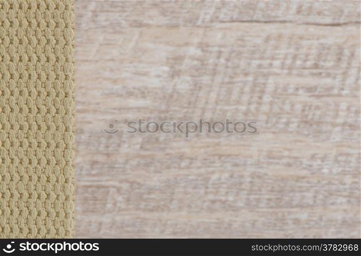 Beige textile belt over wooden background.