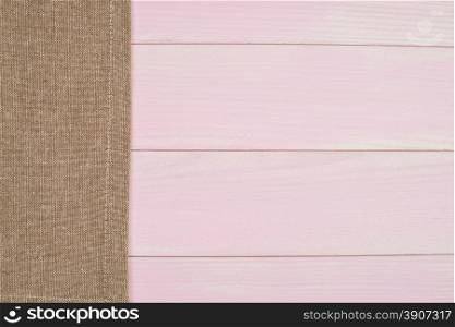 Beige towel over wooden kitchen table. View from above.