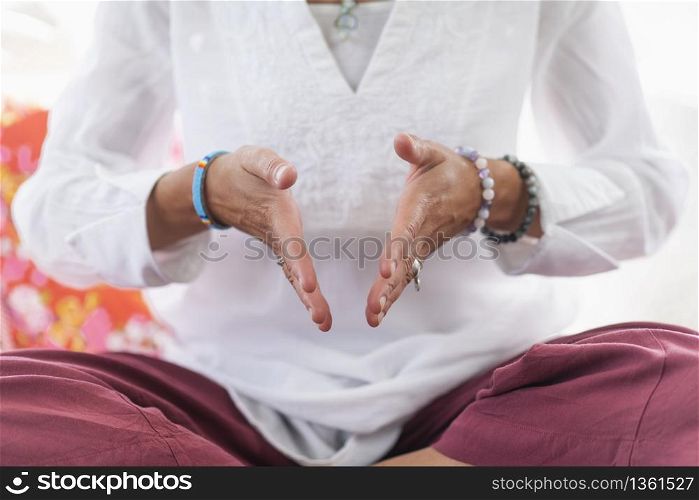 Being in the moment. Woman sitting in lotus position, meditating. Self-care wellbeing practice.. Being in the Moment Meditation Detail