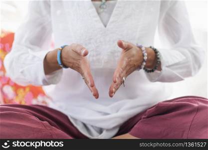 Being in the moment. Woman sitting in lotus position, meditating. Self-care wellbeing practice.. Being in the Moment Meditation Detail
