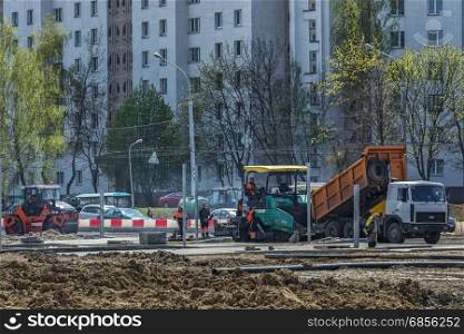 Belarus, Minsk - 06.05.2017: Dump truck, unloads asphalt into special equipment for paving asphalt